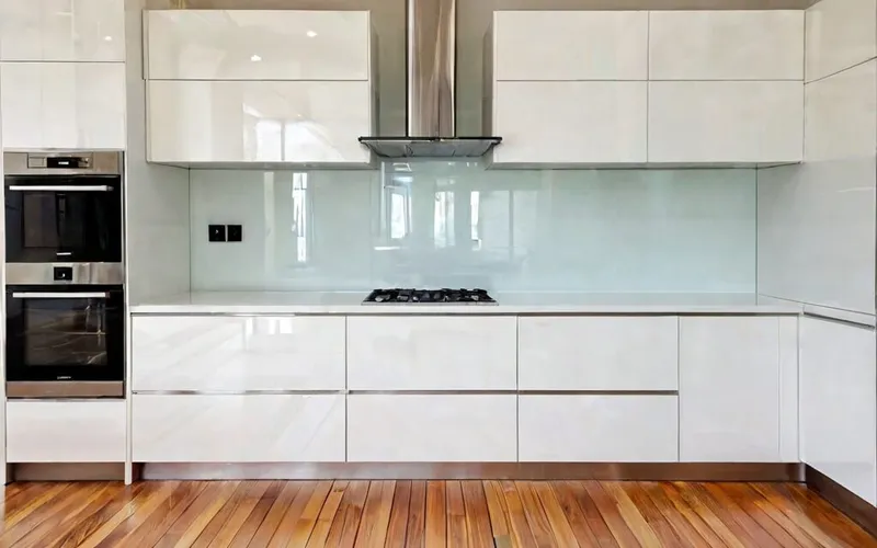 modern kitchen with white gloss cabinets and T-bar handles