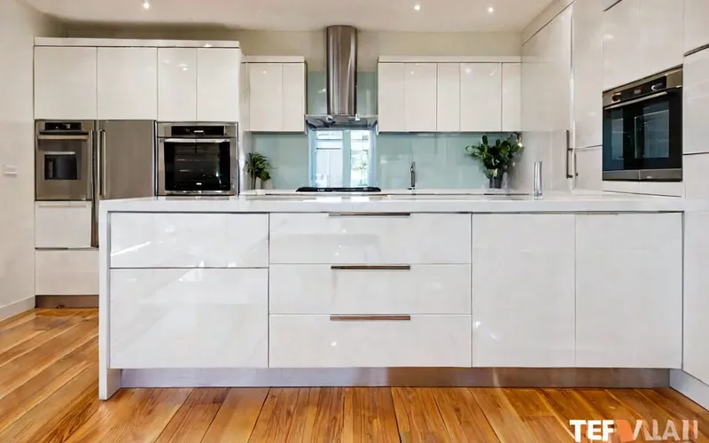 corner kitchen layout with white gloss cabinets and T-bar handles