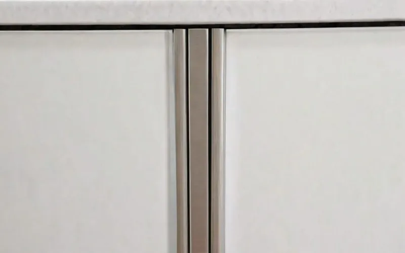 close-up of cabinet with T-bar handle and soft-close drawer