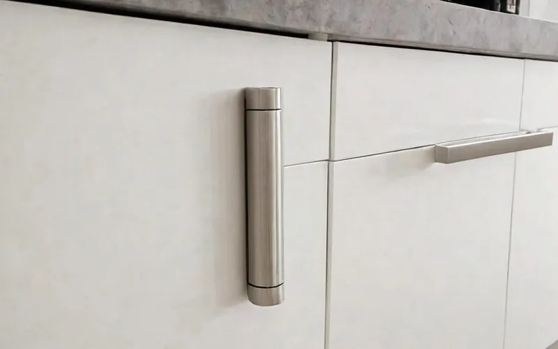 close-up of cabinet with T-bar handle and soft-close drawer