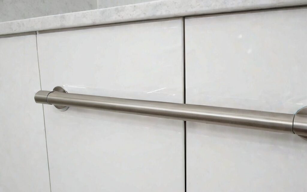 close-up of T-bar handle and gloss white door with soft-close drawer