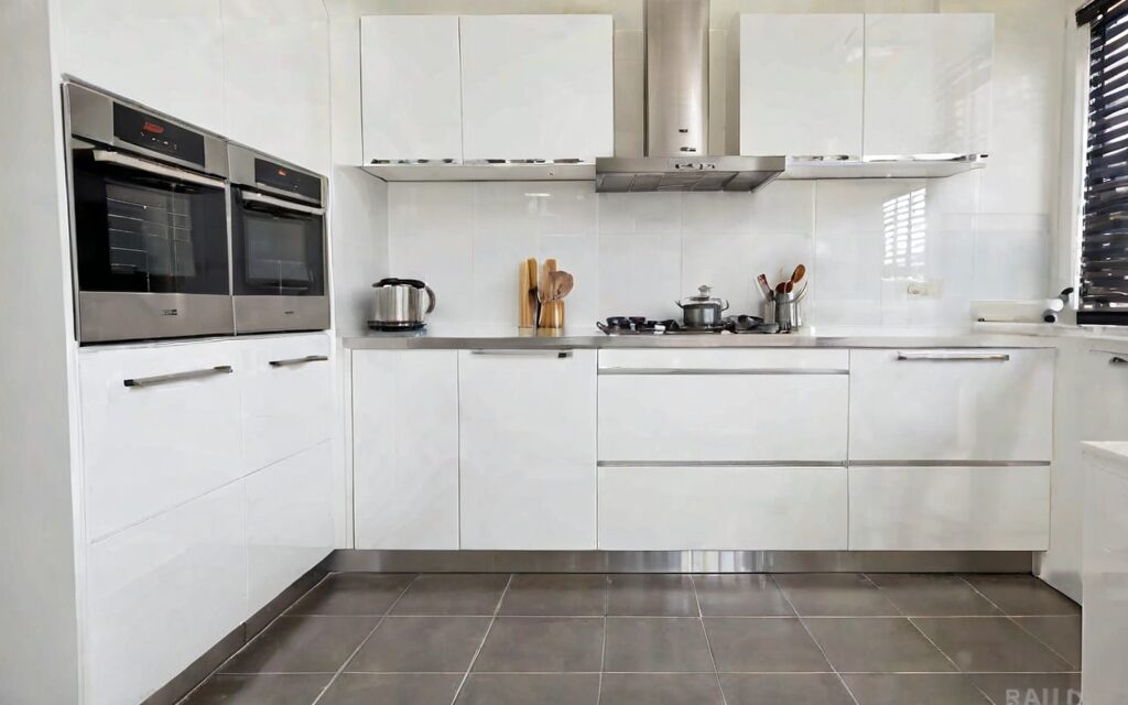 modern galley kitchen with white gloss cabinets and T-bar handles